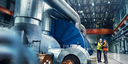 Nærbilde av en ingeniør foran en turbin i et kraftverk